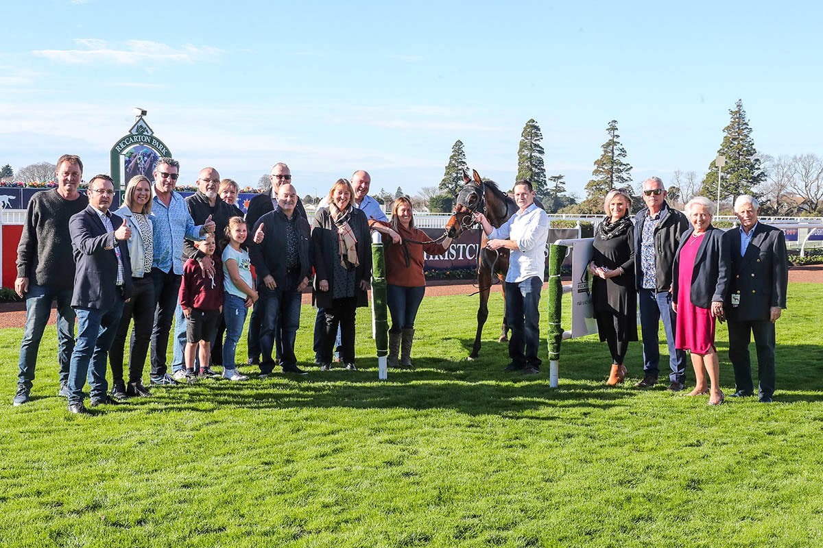 Palmetto is greeted by a big group of supporters after his impressive debut win at Riccarton